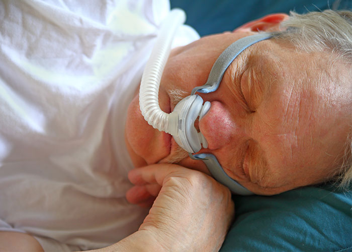 Image of man sleeping with cpap mask on